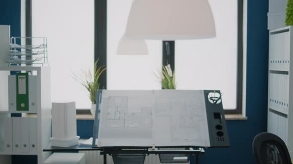 Close Up of Blueprints Plans on Design Table in Empty Architectural Space