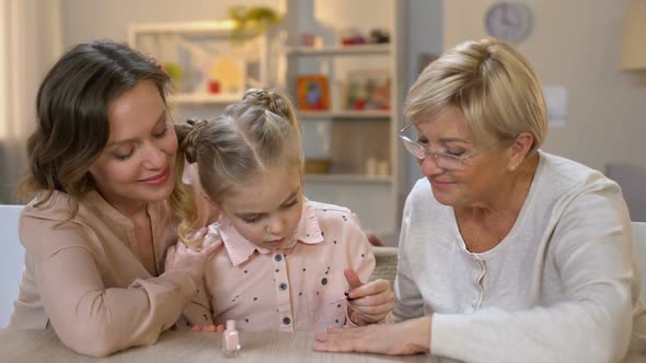 Cute Granddaughter Doing Manicure for Granny, Painting Fingernails at Home