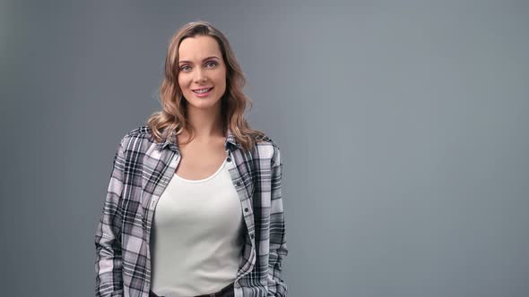 Casual Modern Woman in Checkered Shirt Smiling Posing Isolated on Gray