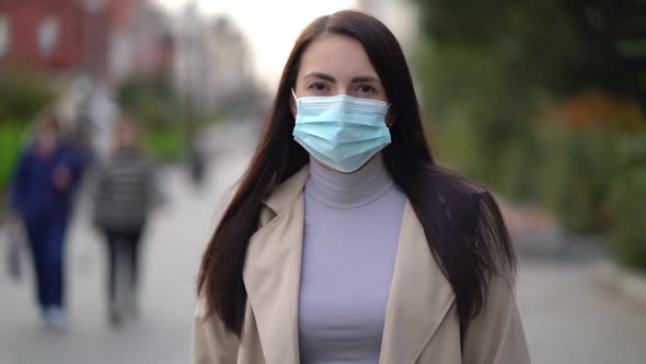Portrait of a Mixed Race Woman in the City Streets During the Day, Wearing a Face Mask Against the