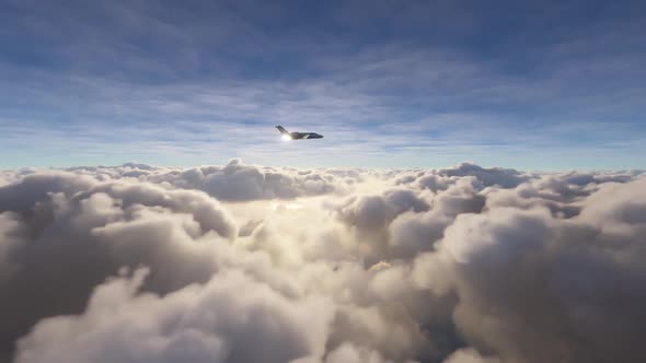 Side view of a private airplane flying over clouds