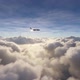 Side view of a private airplane flying over clouds - VideoHive Item for Sale