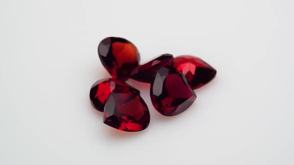 Natural Red Garnet Gemstone on the White Background on the Turning Table