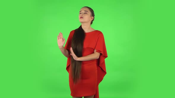 Pretty Young Woman Is Strictly Gesturing with Hands Shape Meaning Denial Saying NO. Green Screen