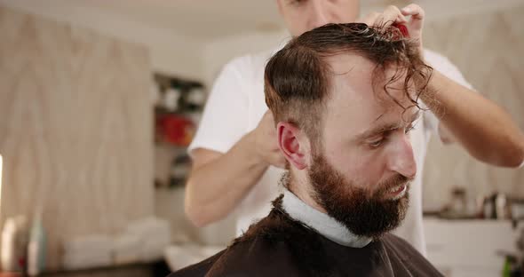 Male Cutting Hair with Scissors Closeup
