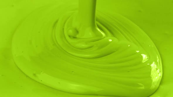 Light Green Paint Is Poured Close-Up