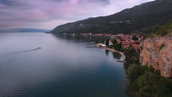 Aerial (drone) dolly backward shot of Macedonian shore in Ohrid Lake, Pesztani and Trpejca