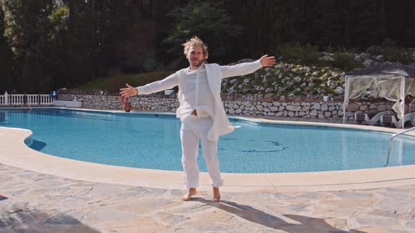 Dancing Barefoot Man In White At Poolside