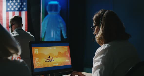 Mars Mission Technicians Working at Their Desk