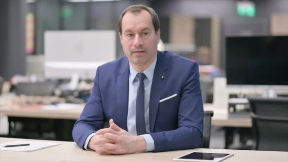 Pensive Businessman Thinking While Sitting in Office