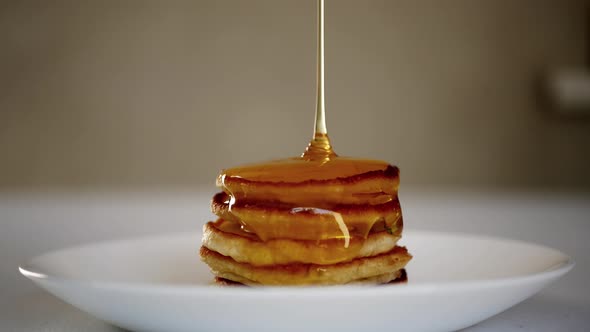 Pouring Honey On Pancakes