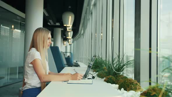 Businesswoman Working with Laptop in New Office