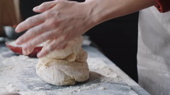 Hands of Female Baker Preparing Dough