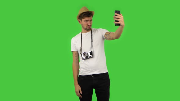 Confident Guy Is Making Selfie on Mobile Phone Then Looking Photos. Green Screen