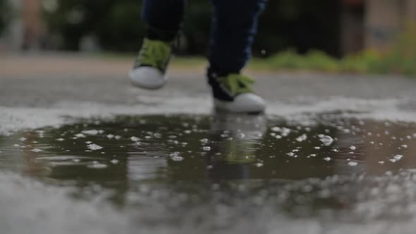 Low Angle, Close-up, Unrecognizable Kids Running Through Puddles Summer Day After Rain