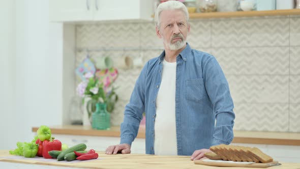 Loving Old Man Shaking Head As No Sign While in Kitchen