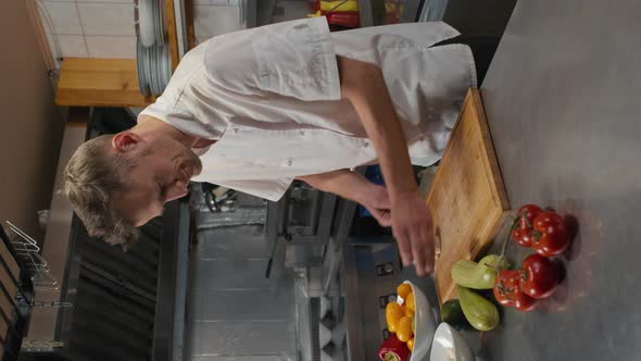 Portrait Of Smiling Chef In Restaurant Kitchen