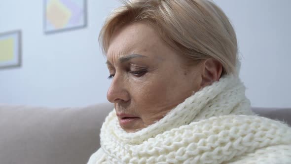 Aged Female in Scarf Coughing and Taking Tablet at Home, Flu or Cold Treatment