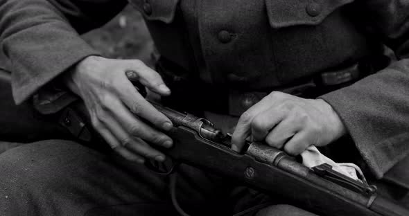 World War II German Soldier Cleaning Rifle