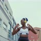 Young woman with headphones exercising in city, Milan, Italy - VideoHive Item for Sale