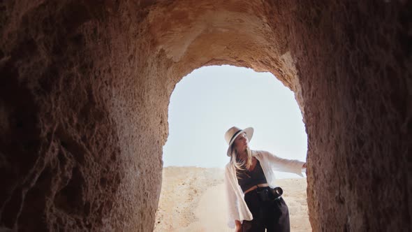 Focused Woman Examining Ruins of Ancient Temple