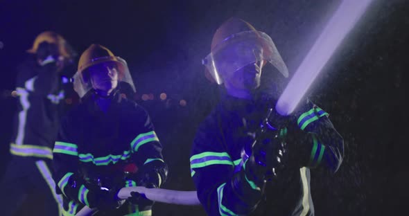 Night Shift of Firefighters Extinguishing the Blaze