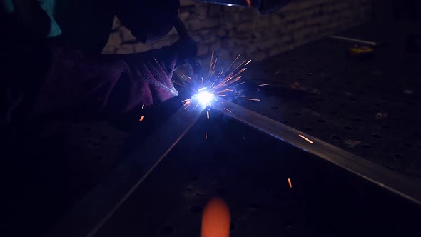 Industry Worker Welding Iron Pieces at Work