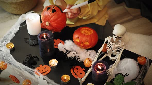 Halloween decoration. Traditional halloween symbols on table in lights of candles, spiders, bats