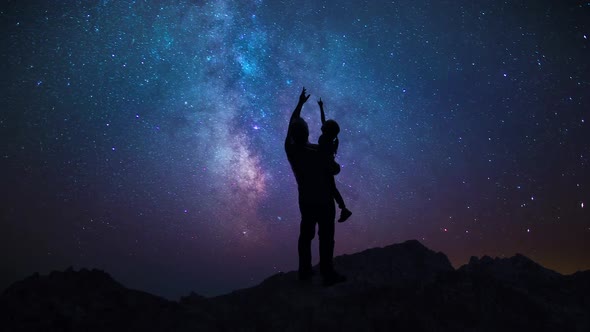 Man Father Showing Daughter Child Night Starry Sky In Mountains