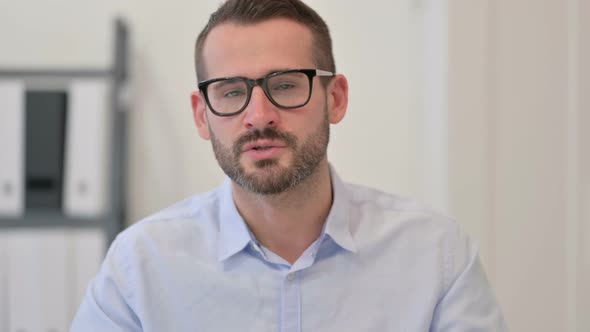 Portrait of Middle Aged Man Talking on Video Call