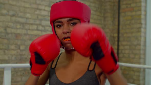 Determined Athletic Black Female Fighter Boxing Inside Boxing Ring