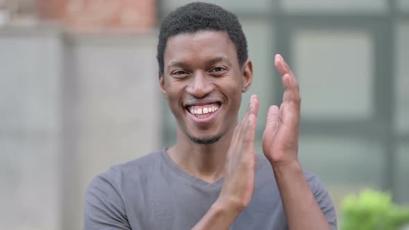 Portrait of Appreciative Young Young African Man Clapping