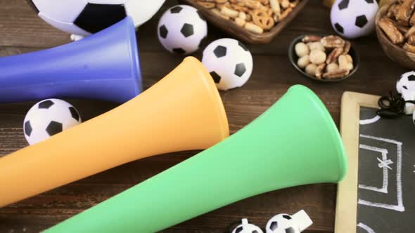 Salty snacks vuvuzela stadium horns on the table to watch football game.