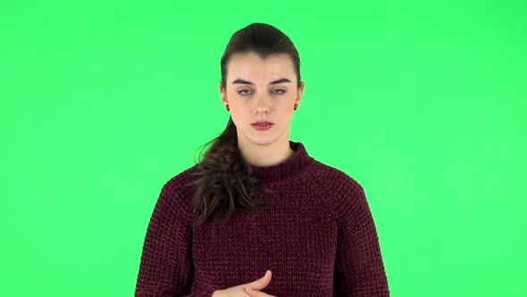 Female Stands Worrying in Expectation Then Smiles with Relief, Carried. Green Screen