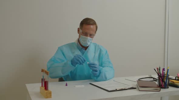 Medical Worker in Protective Workwear Making PCR Test for Coronavirus Disease at Laboratory