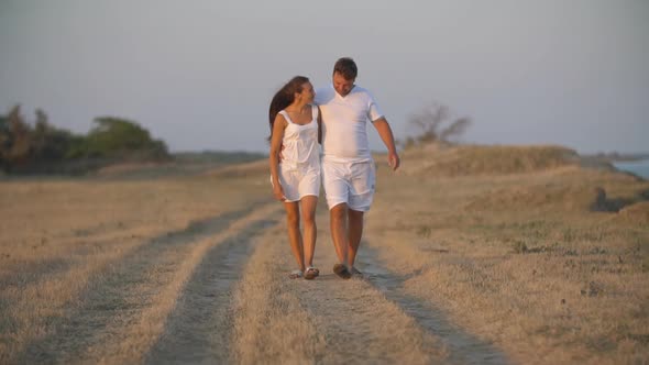 Couple Walking on a Dirt Road