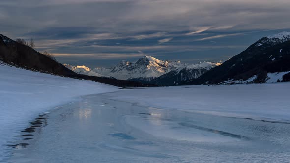 Timelapse of sunset over lake Reschen in winter