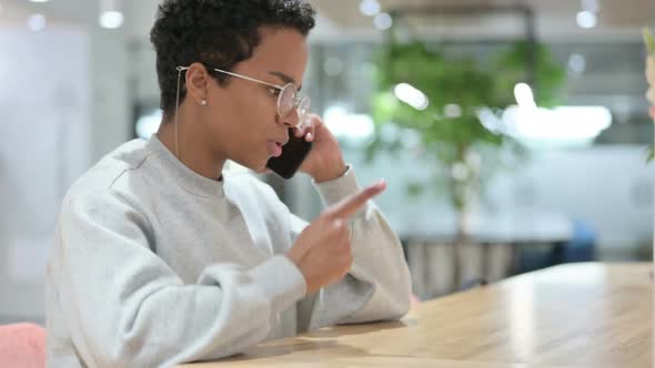 Angry Casual African Woman Talking on Smartphone