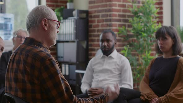 Old Man Making Confession About Alcoholism and Depression in Front of People at Group Therapy