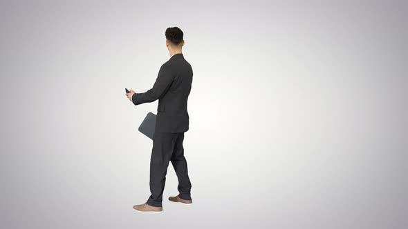 Young Business Man Walking and Taking a Selfie on Gradient Background.