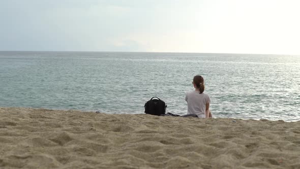 Girl Sitting By the Sea on the Sand in Alanya, Turkey