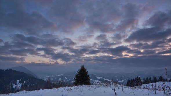 Clouds at sunrise in a winter mountain landscape.