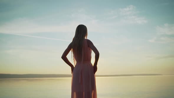 Girl in a Light Dress on the Beach at Sunrise