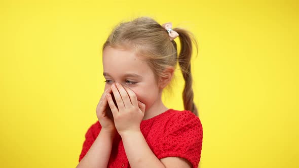 Closeup Portrait of Shy Little Blond Girl with Grey Eyes Talking Holding Hands on Mouth