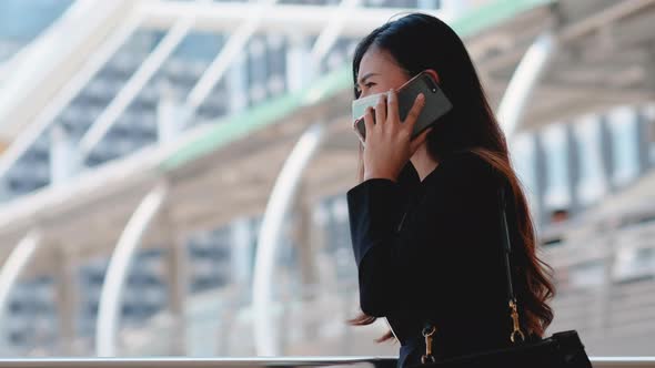 Business woman with mask action of angry or mad after phone call by mobile phone with someone