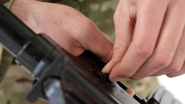 Soldier adjusting rifle