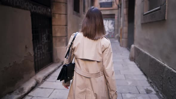 Unrecognizable Stranger Woman Walking Alone in Empty Narrow Street