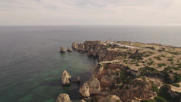 Aerial wide of Ponta da Piedade in Lagos Algarve, Portugal under Sunset