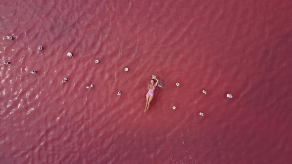 Woman Is Sunbathing in a Striped Bathing Suit