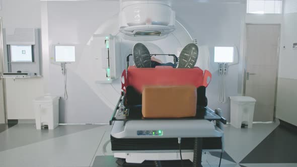 Patient Getting Radiation Therapy Treatment Inside A Modern Radiotherapy Room